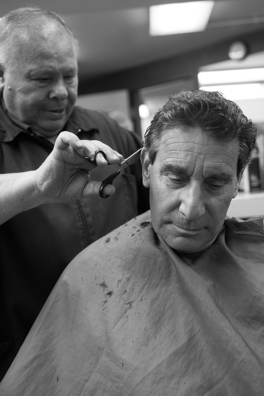 Sil Vigilante cuts a client’s hair last year, prior to the closing of the barbershop in Reynolds Club.