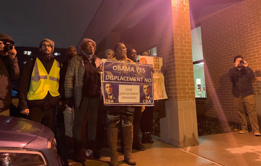 Pro-CBA activists hold a sign proclaiming "Obama Yes, Displacement No."